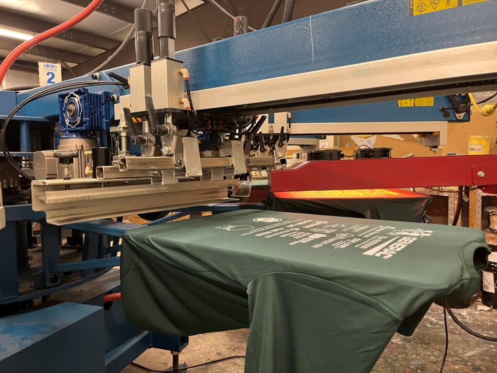 Green Shirt on Screen Printing Press